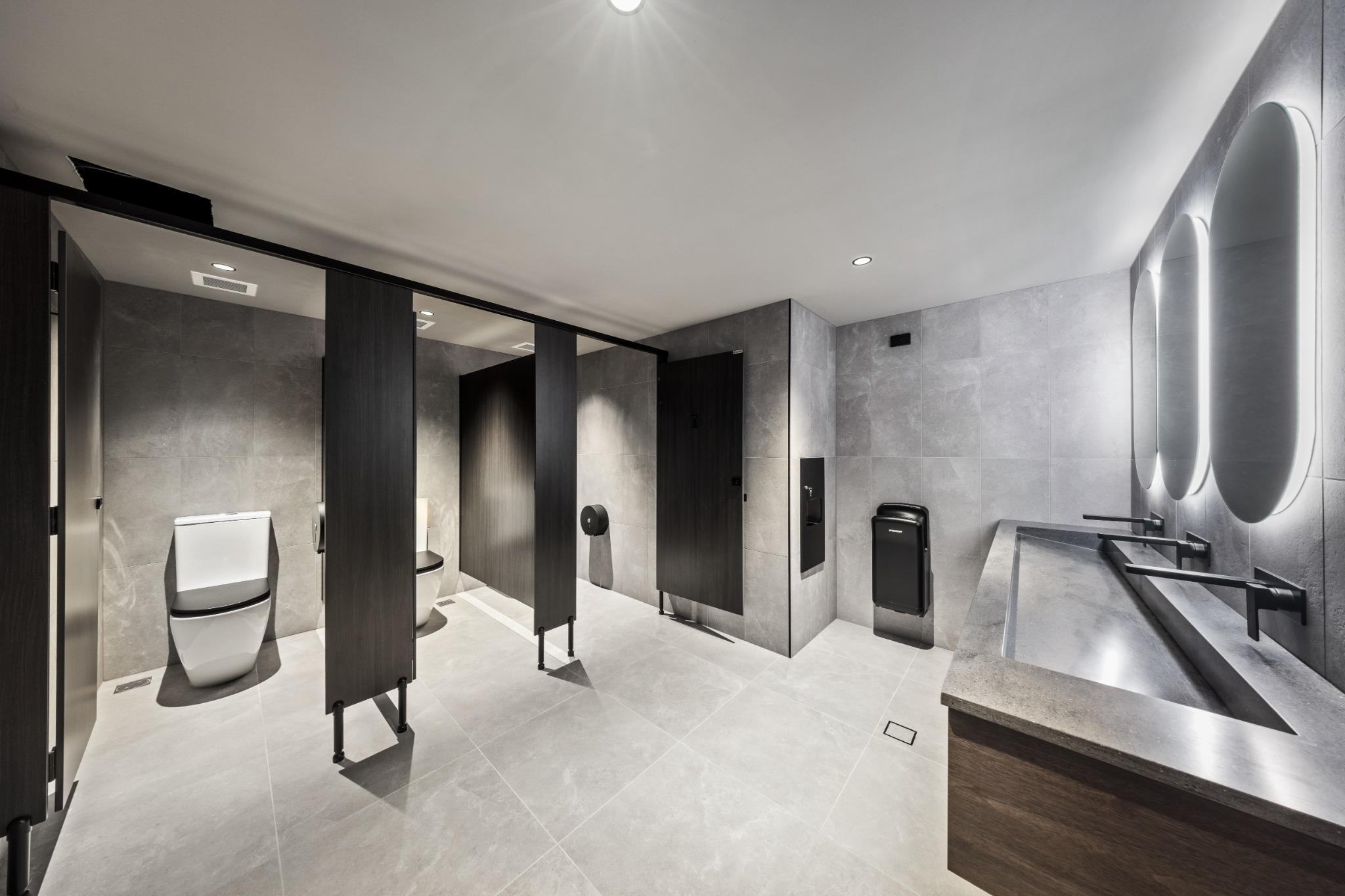 Infinity Group Australia office amenities designed by Leithal Designs featuring contemporary commercial bathroom fitout with premium fixtures and natural finishes.