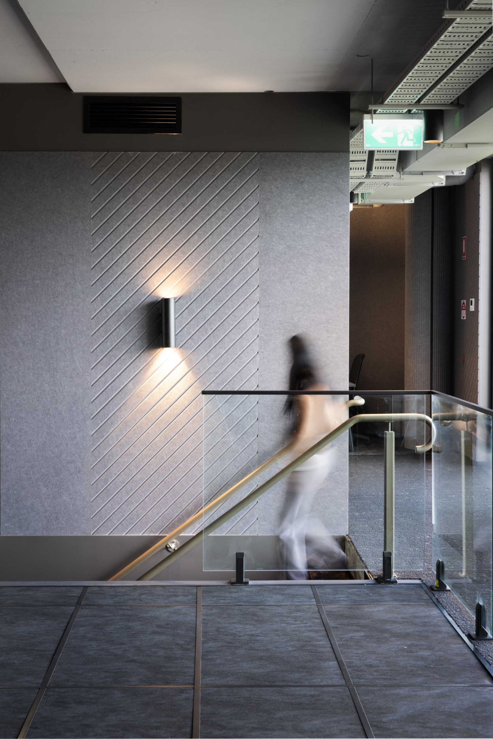 Infinity Group Australia office interior with LPA architectural wall lighting and Woven Image acoustic wall panels, designed by Leithal Designs to enhance acoustic performance and contemporary aesthetics.