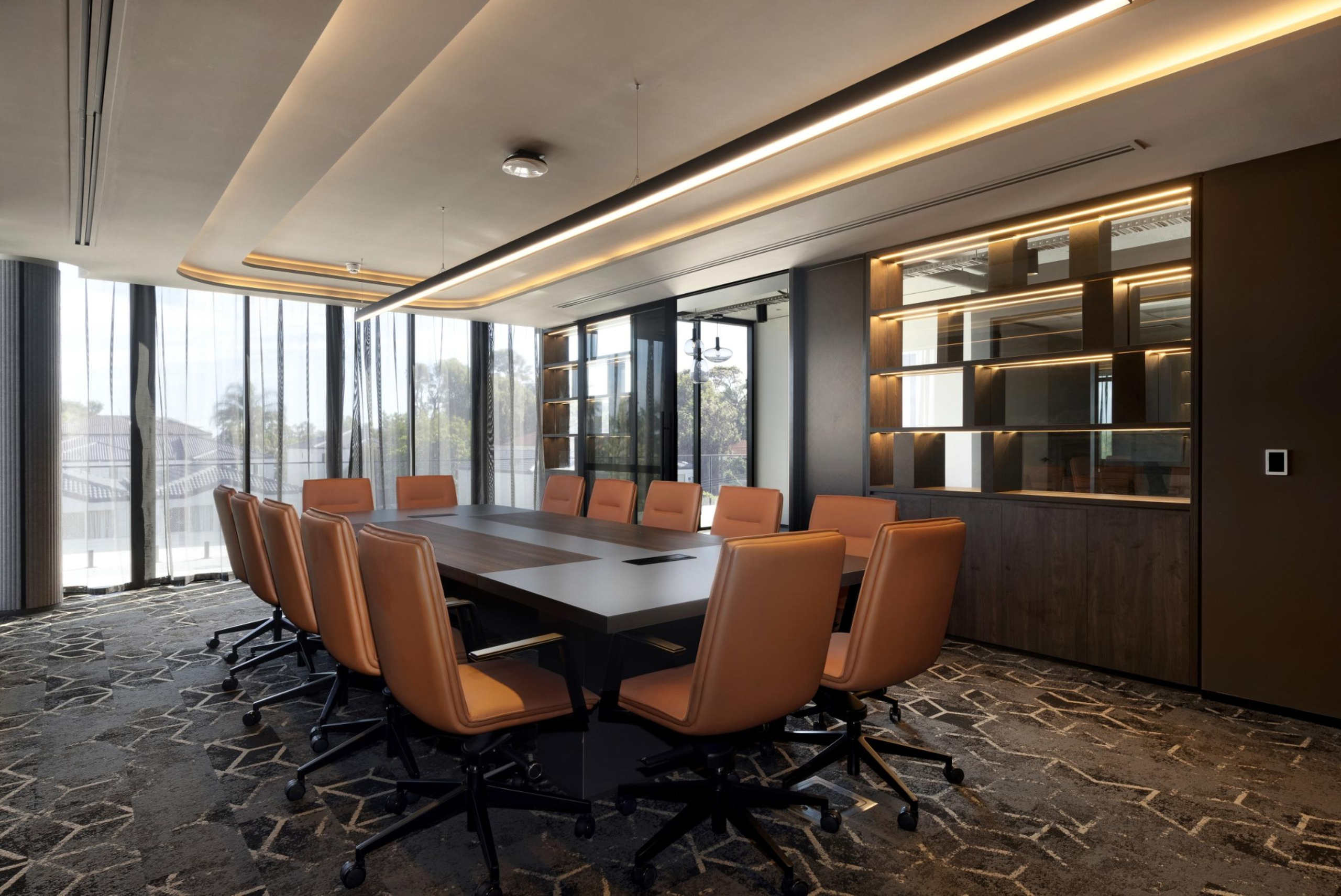 Infinity Group Australia’s Southport boardroom by Leithal Designs, seating 15 executives with bespoke joinery, advanced AV integration, and a refined interior palette.
