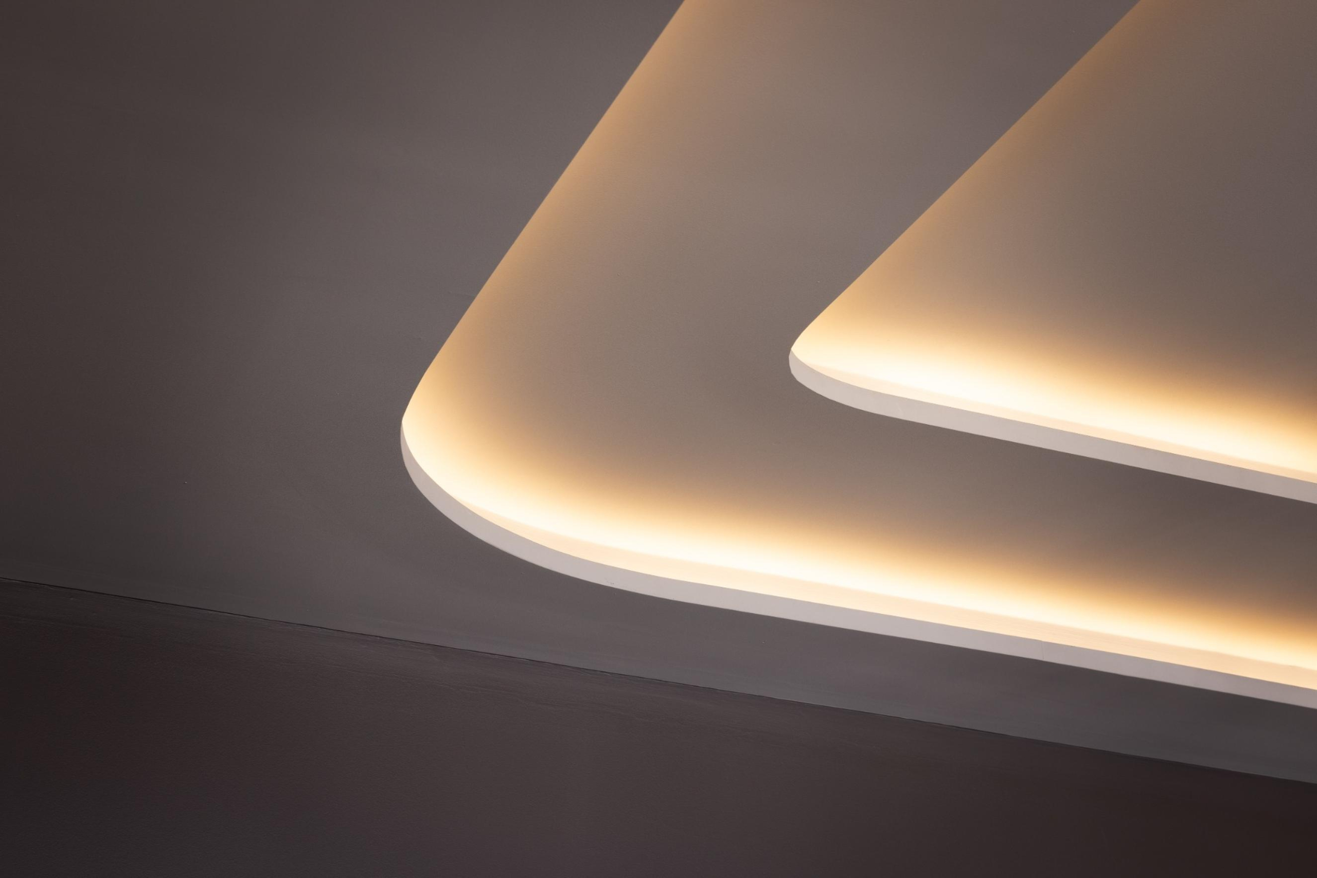Executive boardroom ceiling at Infinity Group Australia's Southport office, featuring layered detailing and integrated LPA LED lighting strips, designed by Leithal Designs for visual impact and ambient illumination.