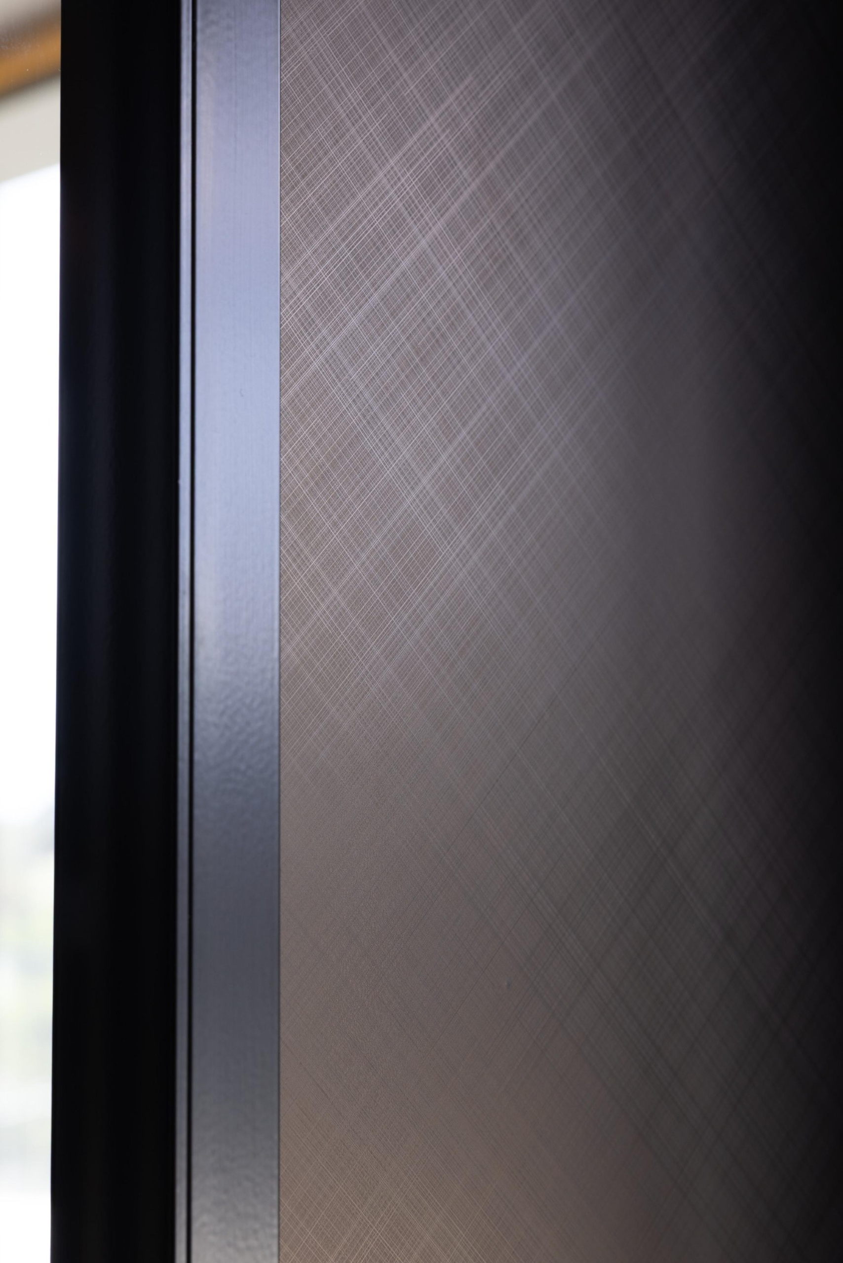 Leithal Designs' entry to executive boardroom at Infinity Group Australia, featuring sliding doors with Baresque vinyl finish and powdercoated full-length handles for a refined corporate aesthetic.