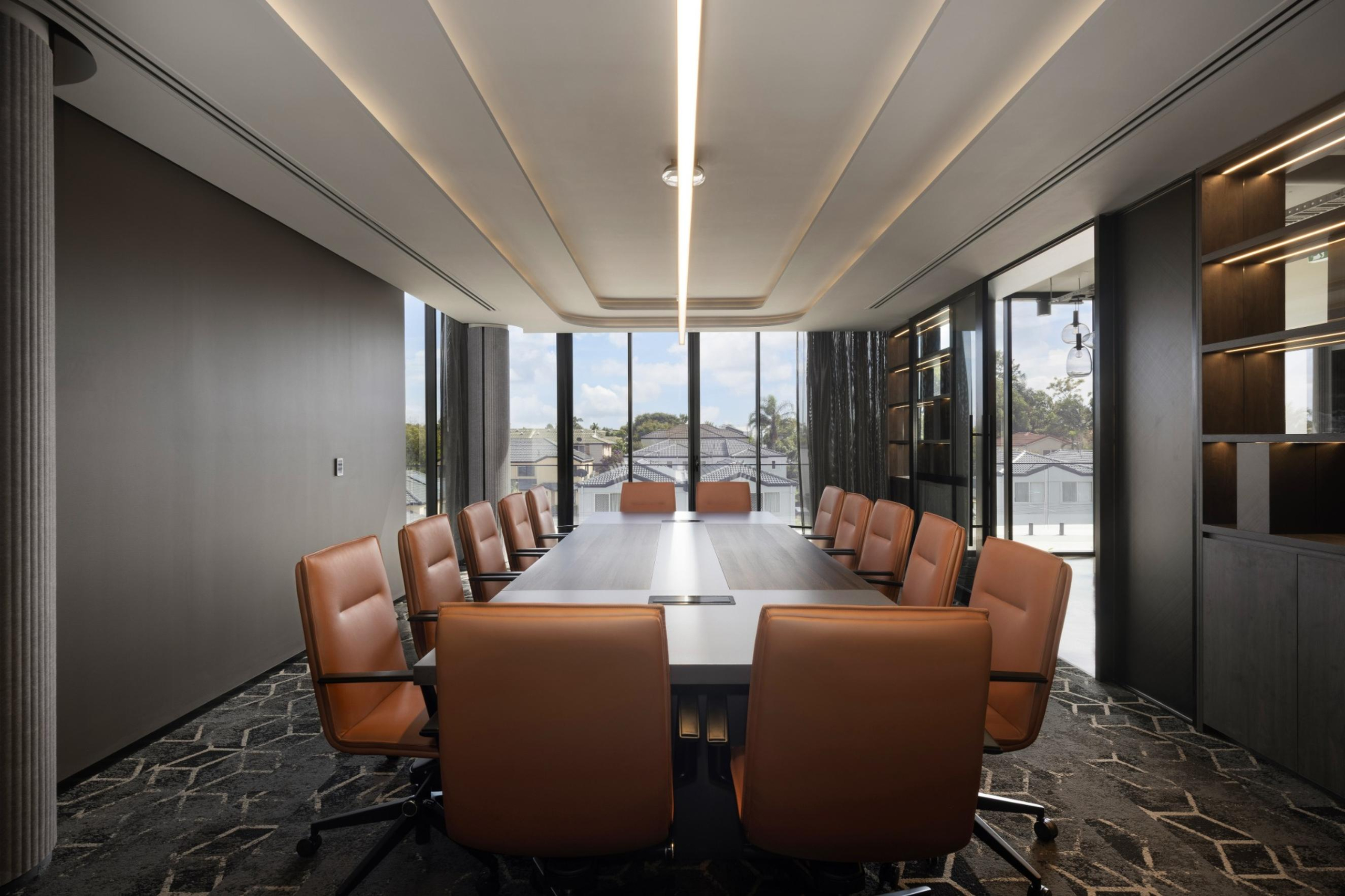 Infinity Group Australia’s Southport boardroom by Leithal Designs, seating 15 executives with bespoke joinery, advanced AV integration, and a refined interior palette.