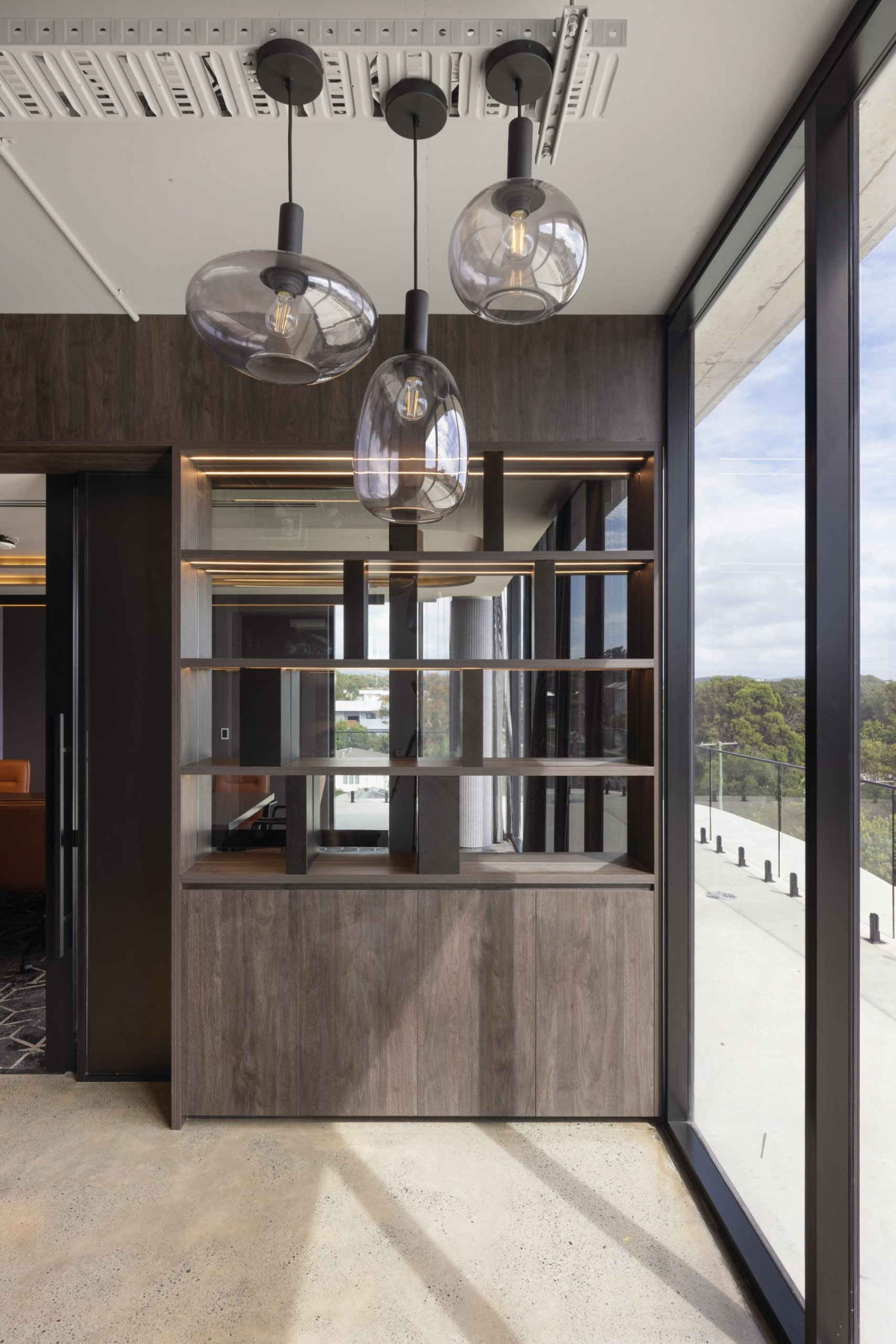 Executive foyer on Level 3 of Infinity Group Australia’s Southport office, with custom awards display and premium finishes designed by Leithal Designs to elevate the client experience.
