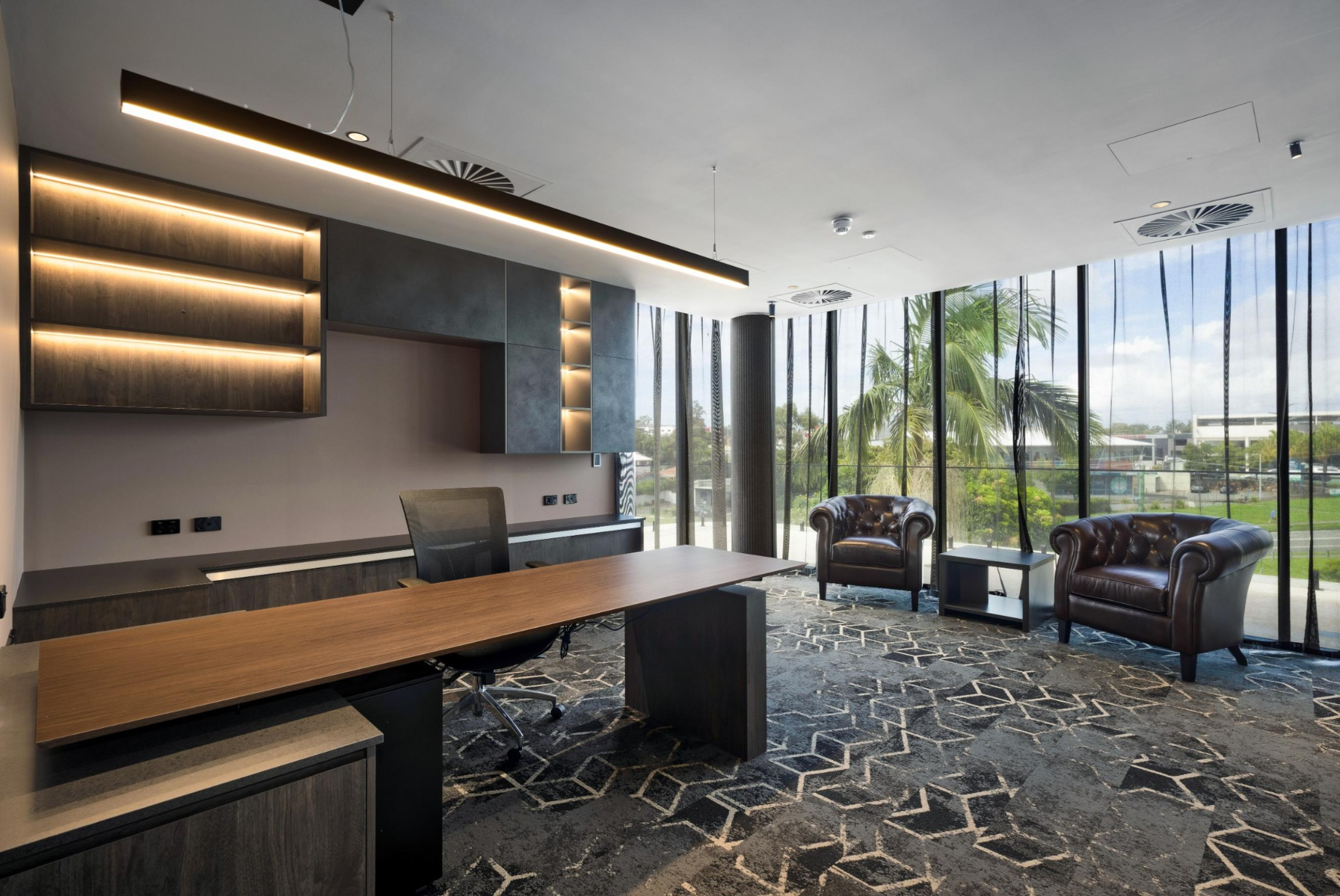 High-end executive office and workstation area at Infinity Group Australia's Southport headquarters, featuring custom joinery and LPA Lighting solutions by Leithal Designs.