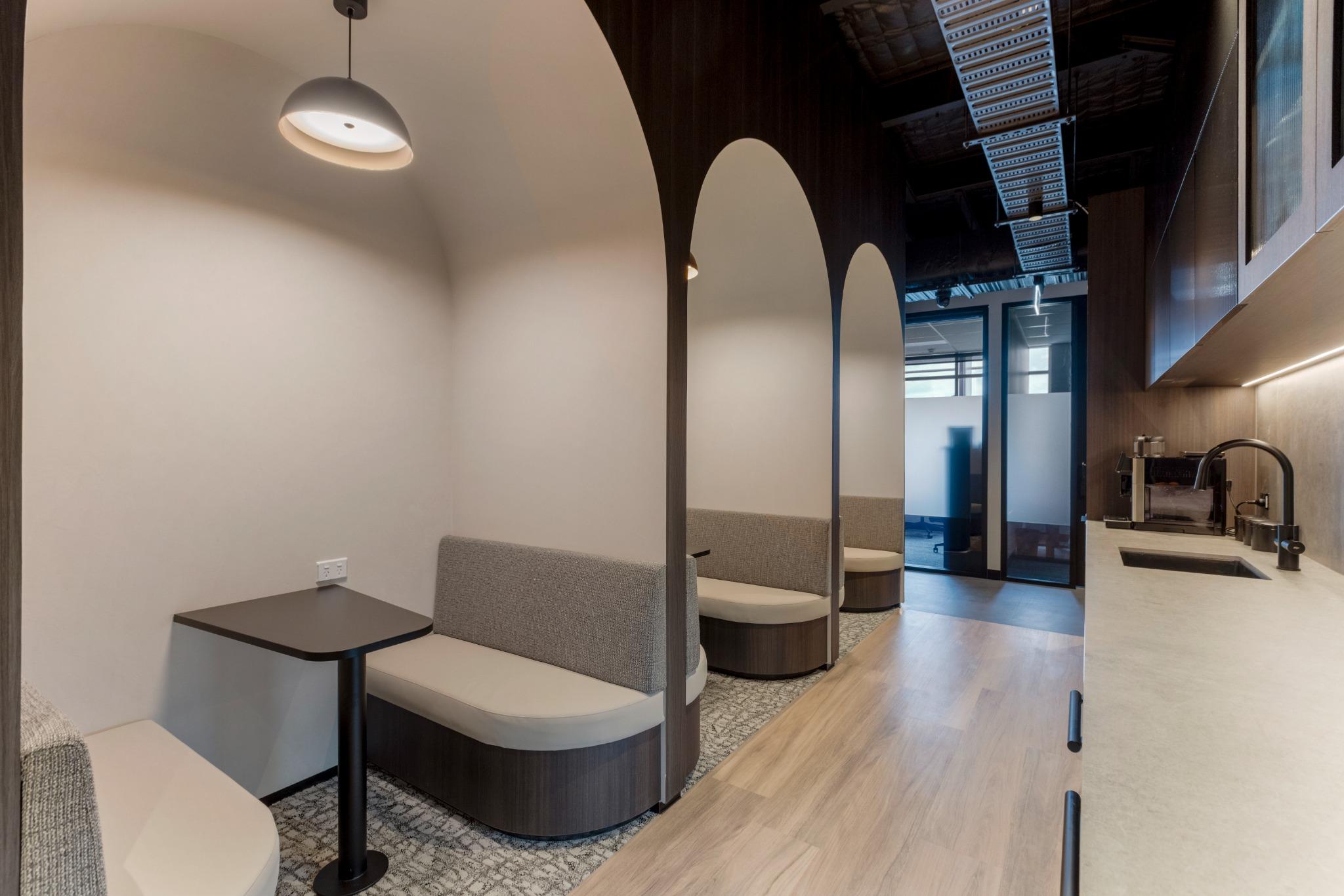 Commercial kitchen and arched booths – coworking office design with hospitality finishes in Robina