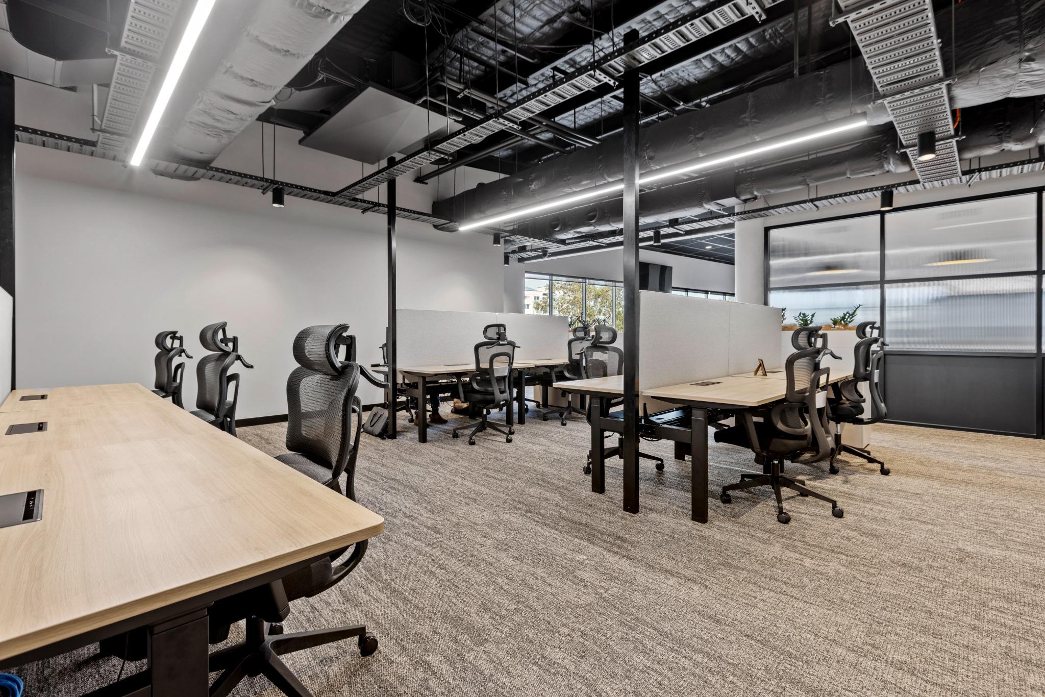 Team office suite with workstation seating for eight – flexible office design in Robina coworking space