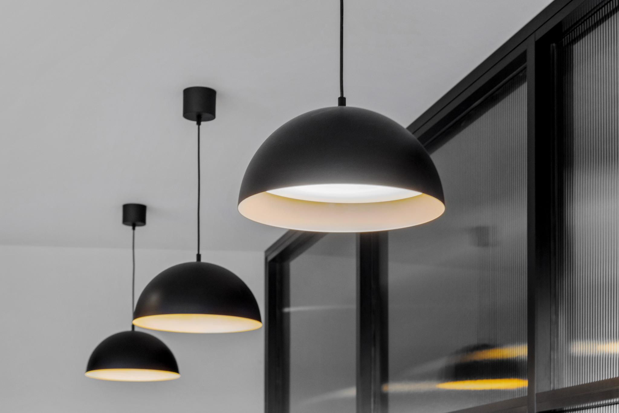 Black dome pendant lights with matte finish – contemporary office lighting detail in coworking fitout