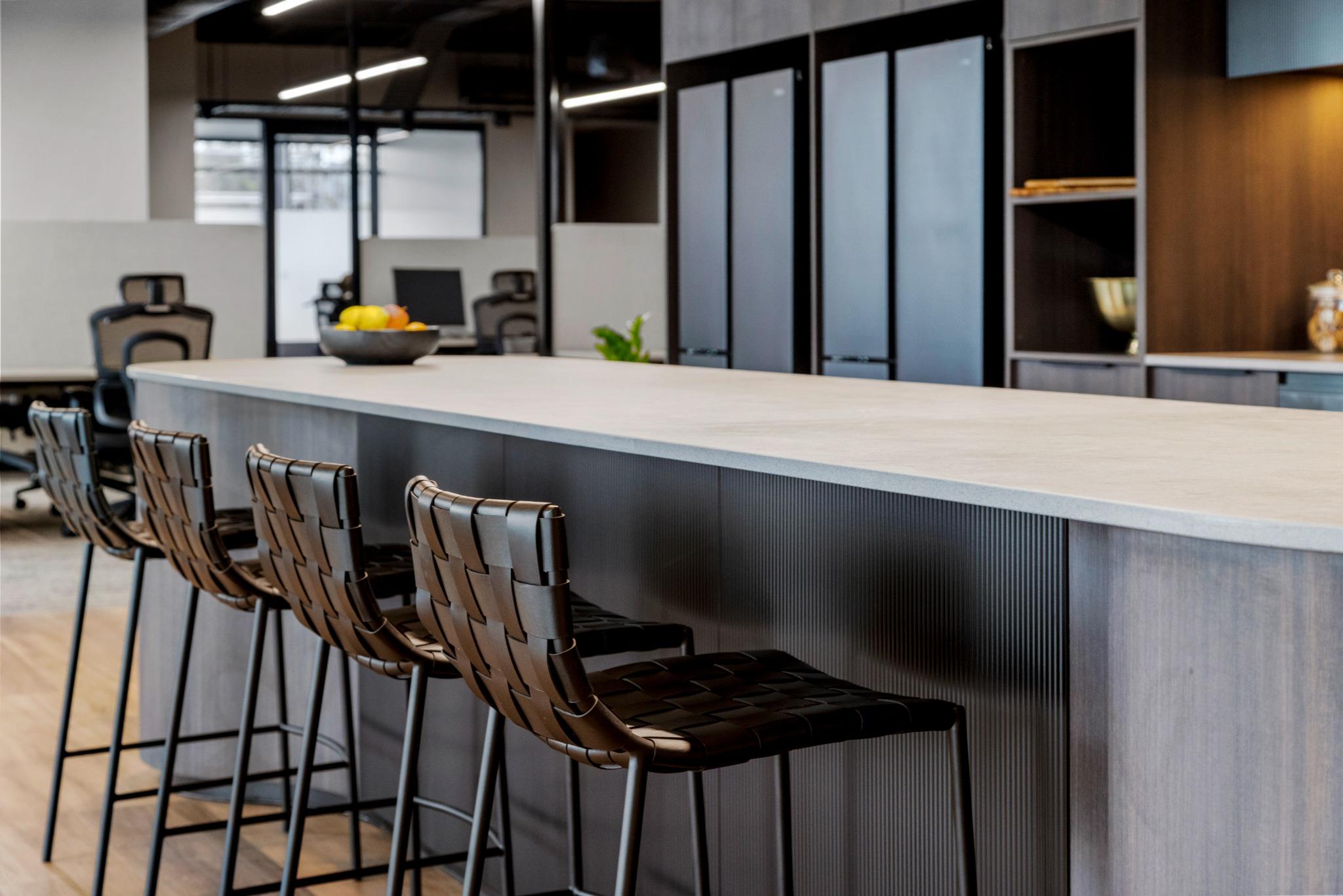 Kitchen island with woven leather barstools – coworking office kitchen design Robina Gold Coast