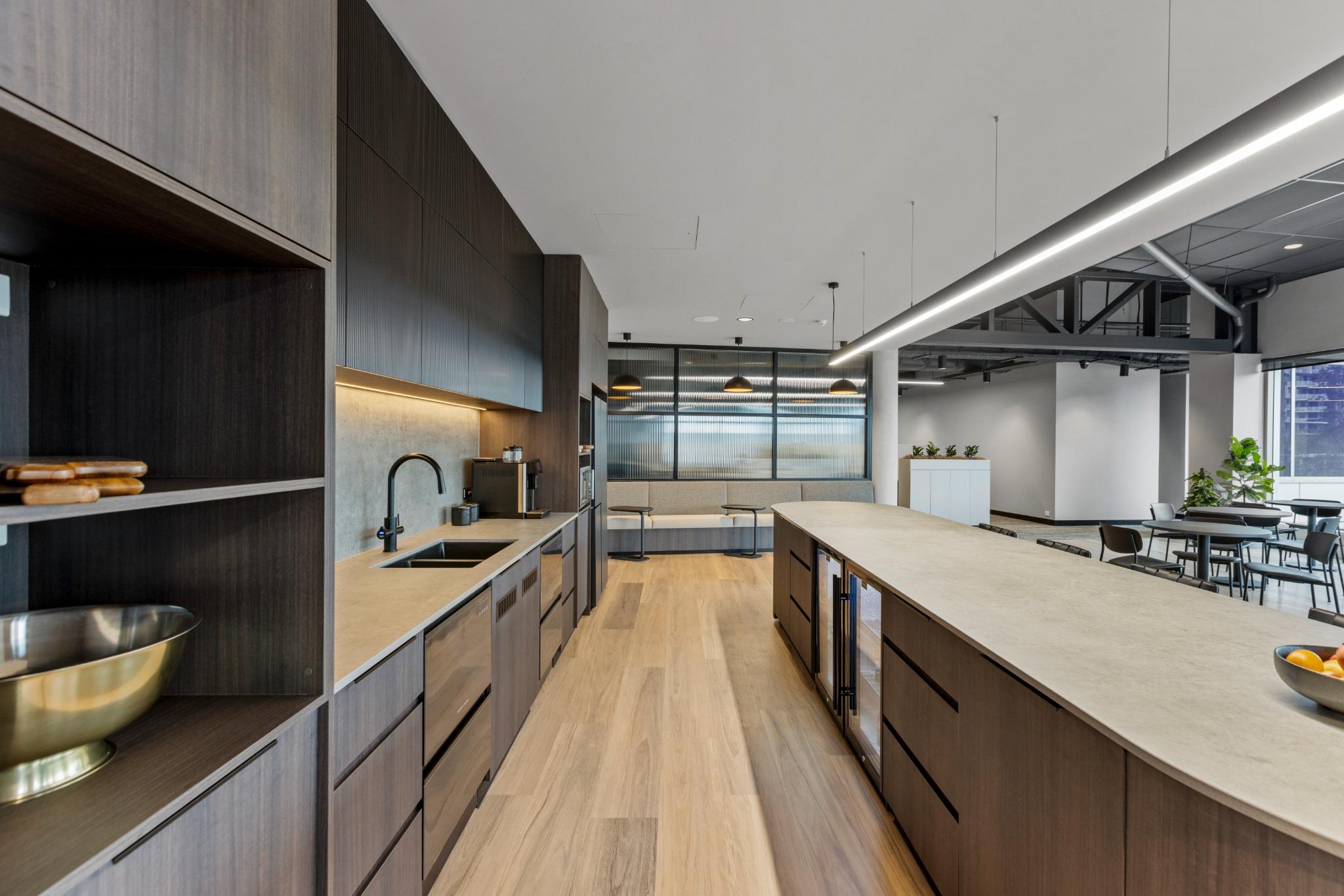 Flexible coworking breakout kitchenette zone with custom joinery and full-height windows – interior fitout Gold Coast